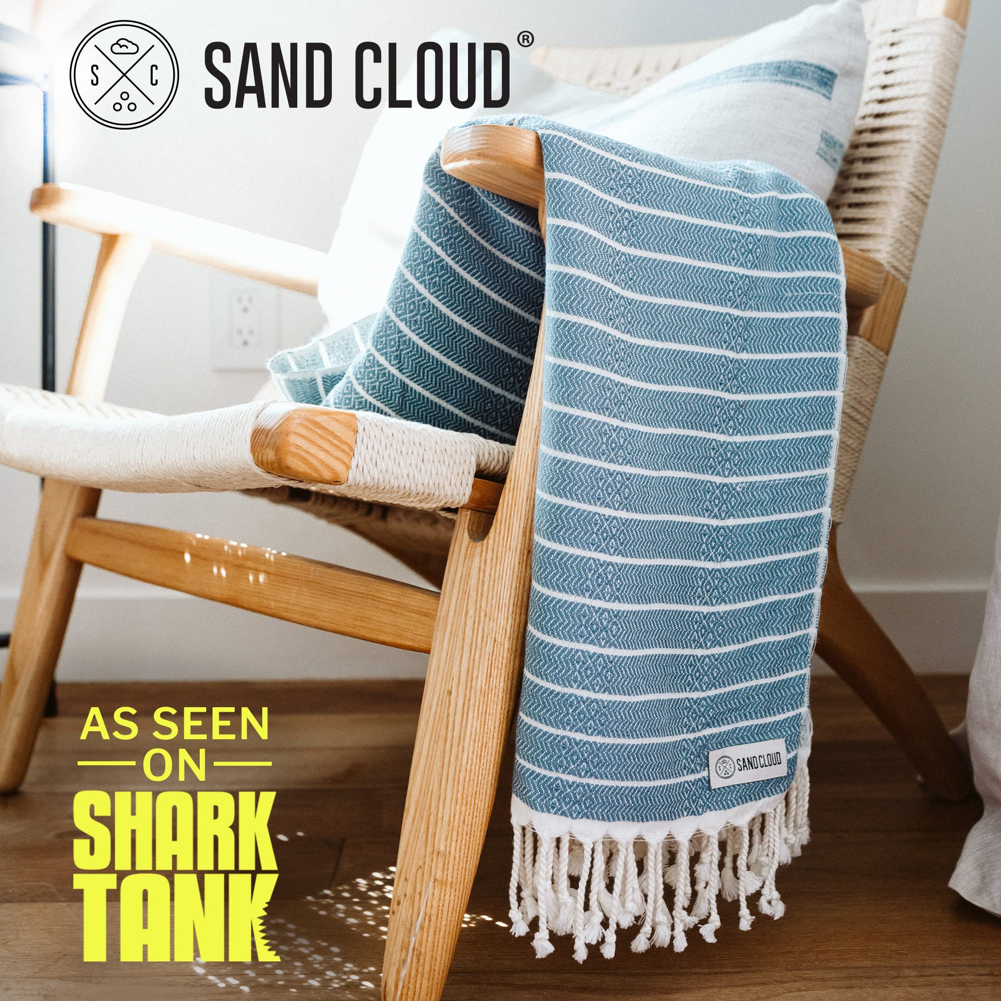 Sand Cloud Turkish Beach Towel demonstrates quick-dry performance after a splash at the poolside.