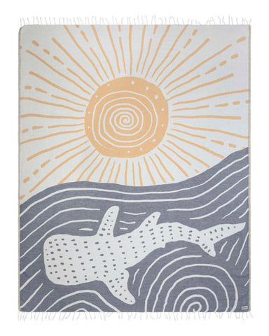Sand Cloud Typus Whale Shark XL towel laid out for beach lounging with sun protection.