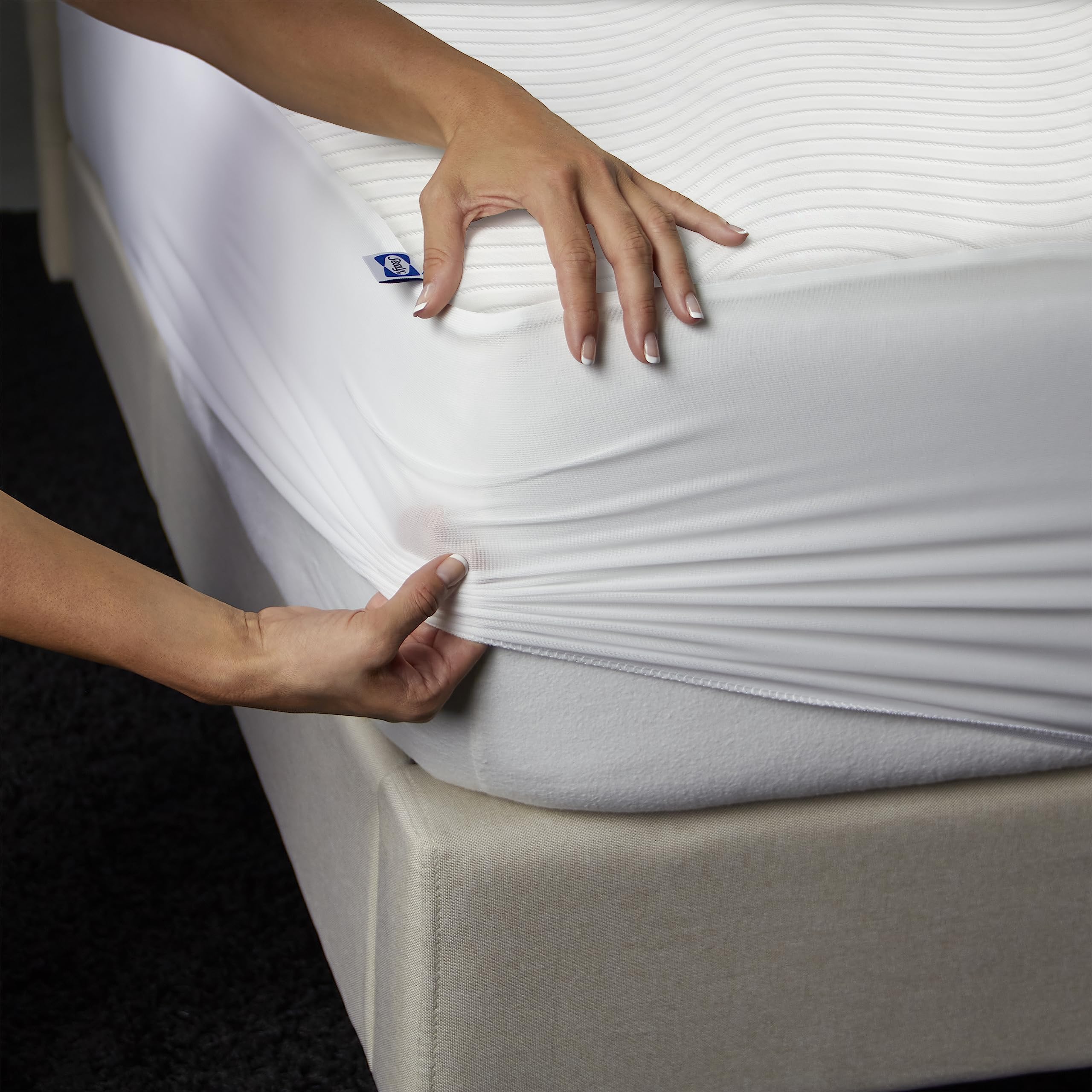 Sealy Queen size white mattress protector blends with bedding style.