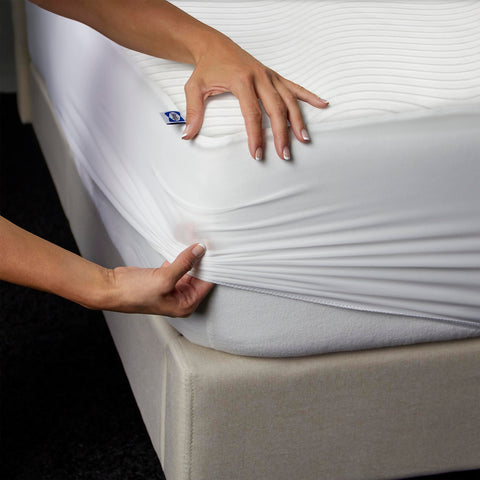 Sealy Queen size white mattress protector blends with bedding style.