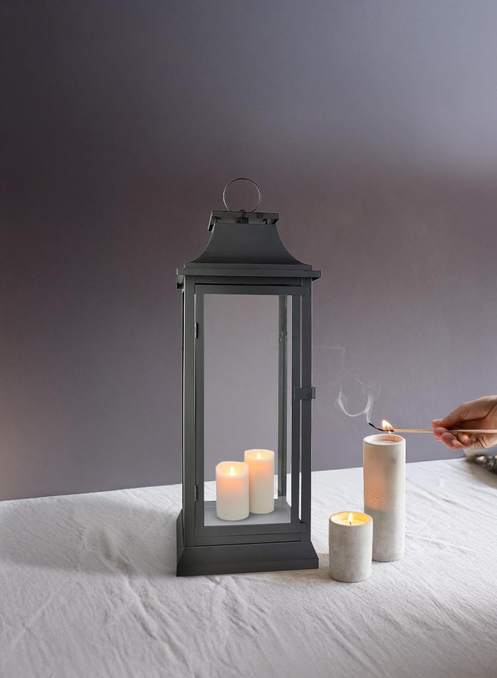 Serene Spaces Living hurricane lantern with clear glass panels protects flame while showcasing light.