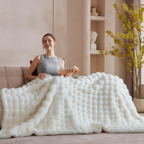 Serenhom ivory-white throw draped on bed for relaxing comfort.