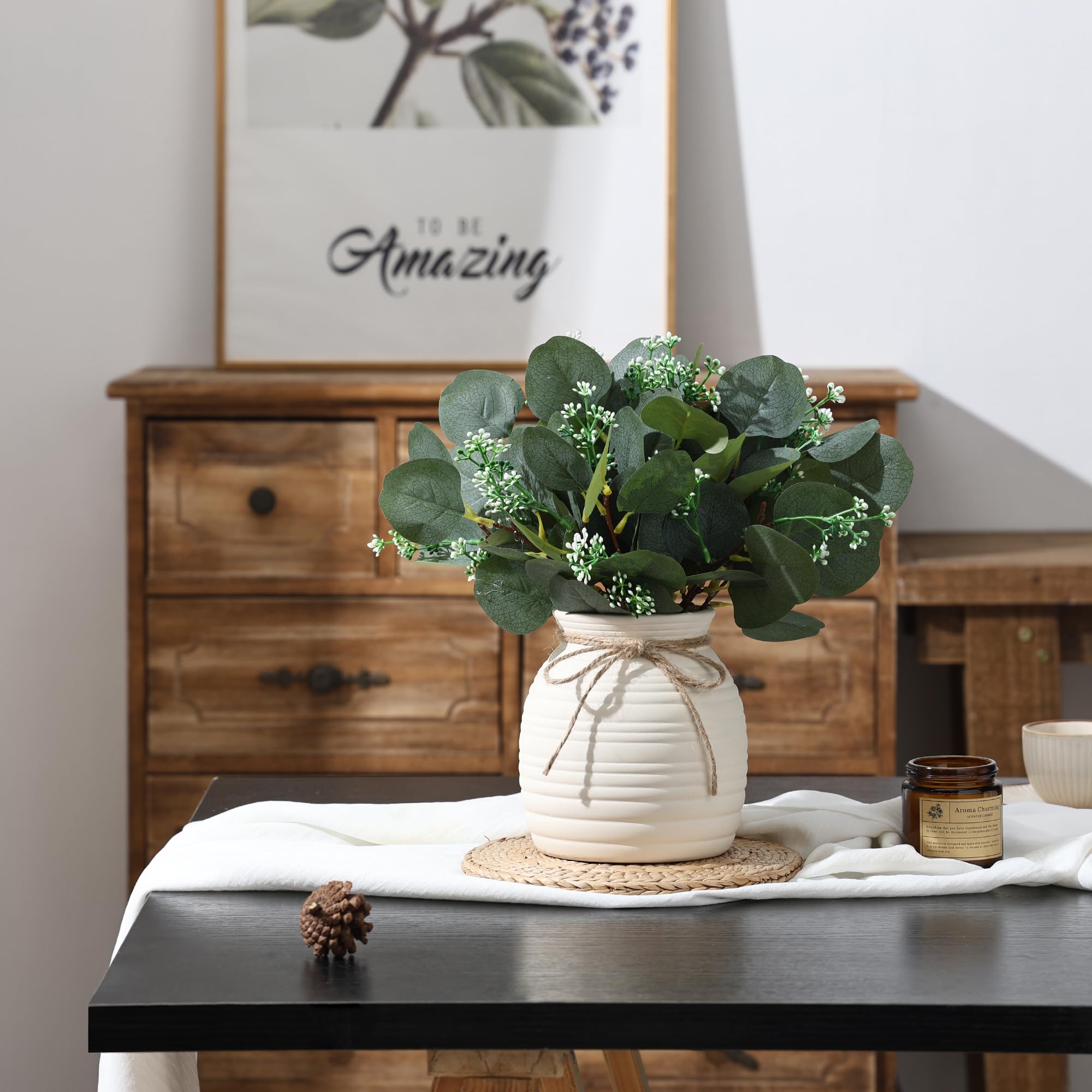 Shanranplus ceramic vase with faux greenery brightens entryways.