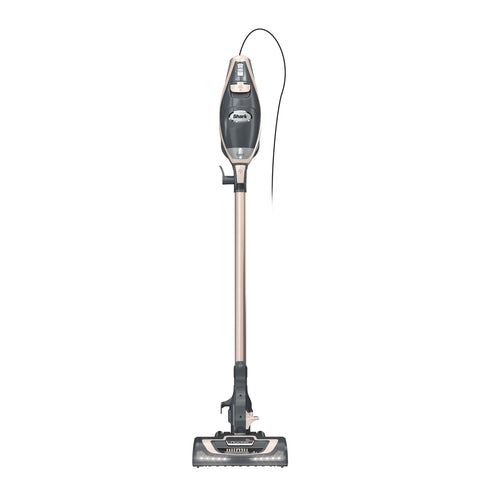 Shark Rocket Pro DLX corded stick vacuum with LED headlights illuminating debris on hardwood