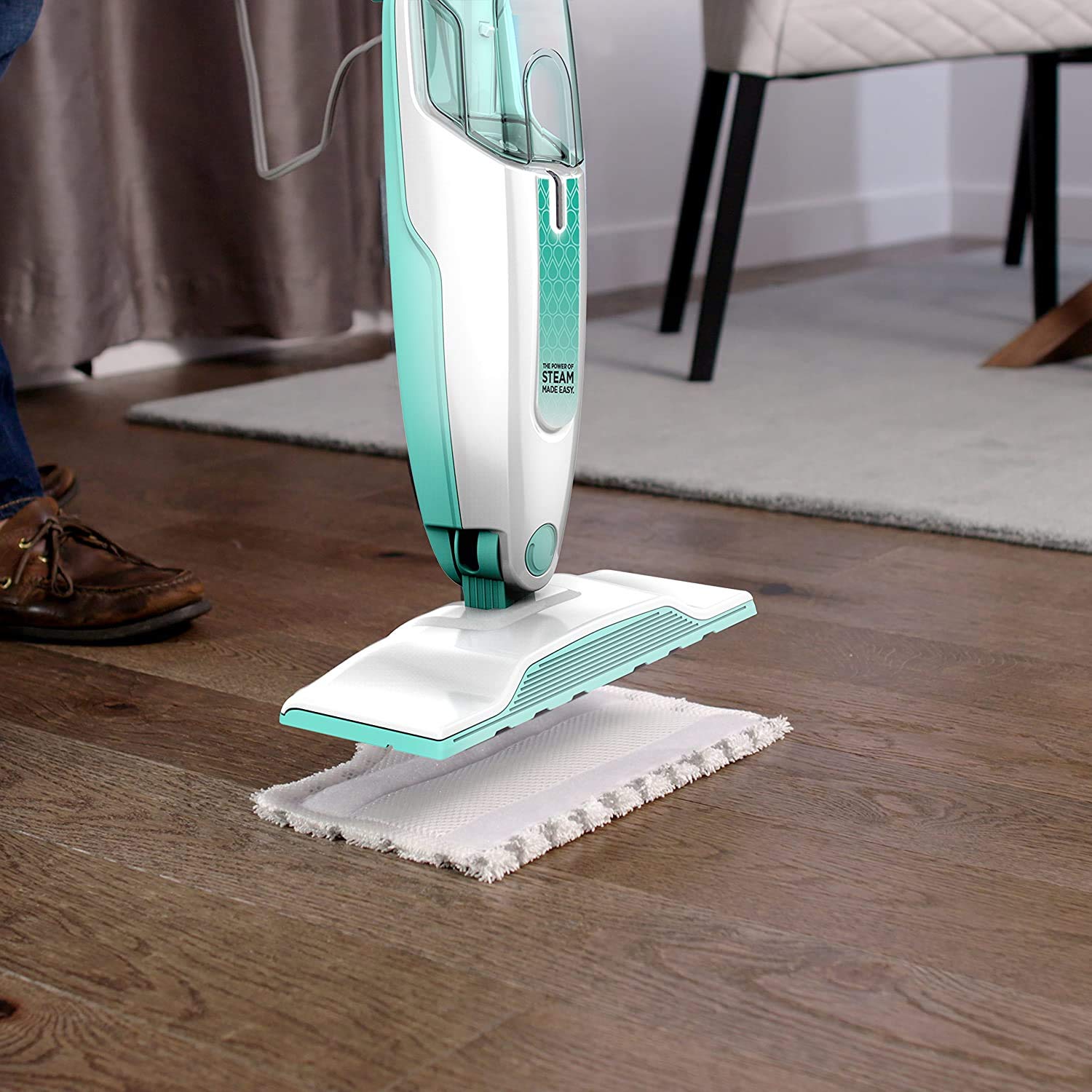 Shark S1000WM steam mop near baseboard edge for thorough edge cleaning.