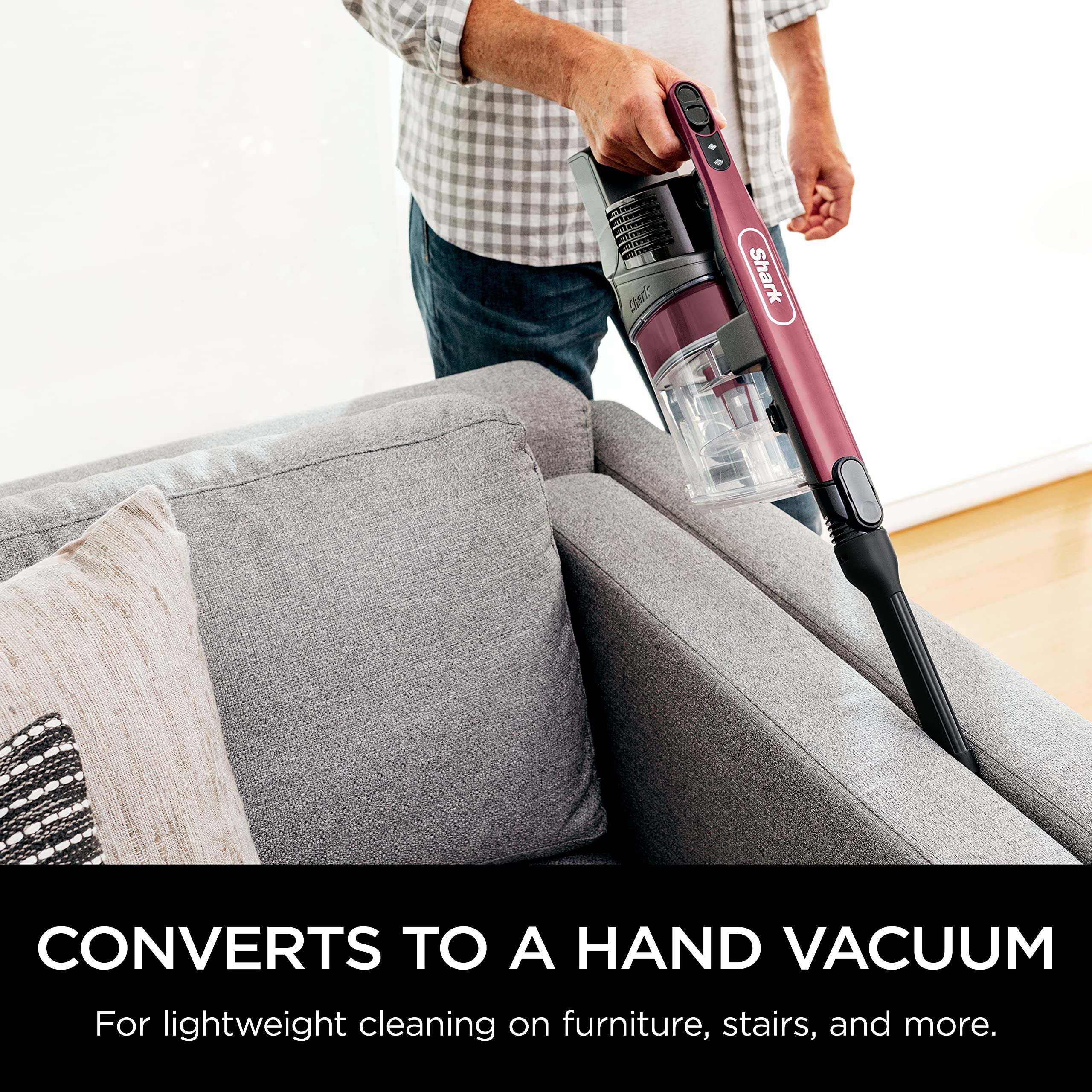 Shark vacuum low-profile design demonstrated under furniture.