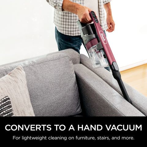 Shark vacuum low-profile design demonstrated under furniture.