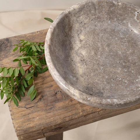 Shelf & Nook travertine bowl bathroom potpourri display adds rustic charm.