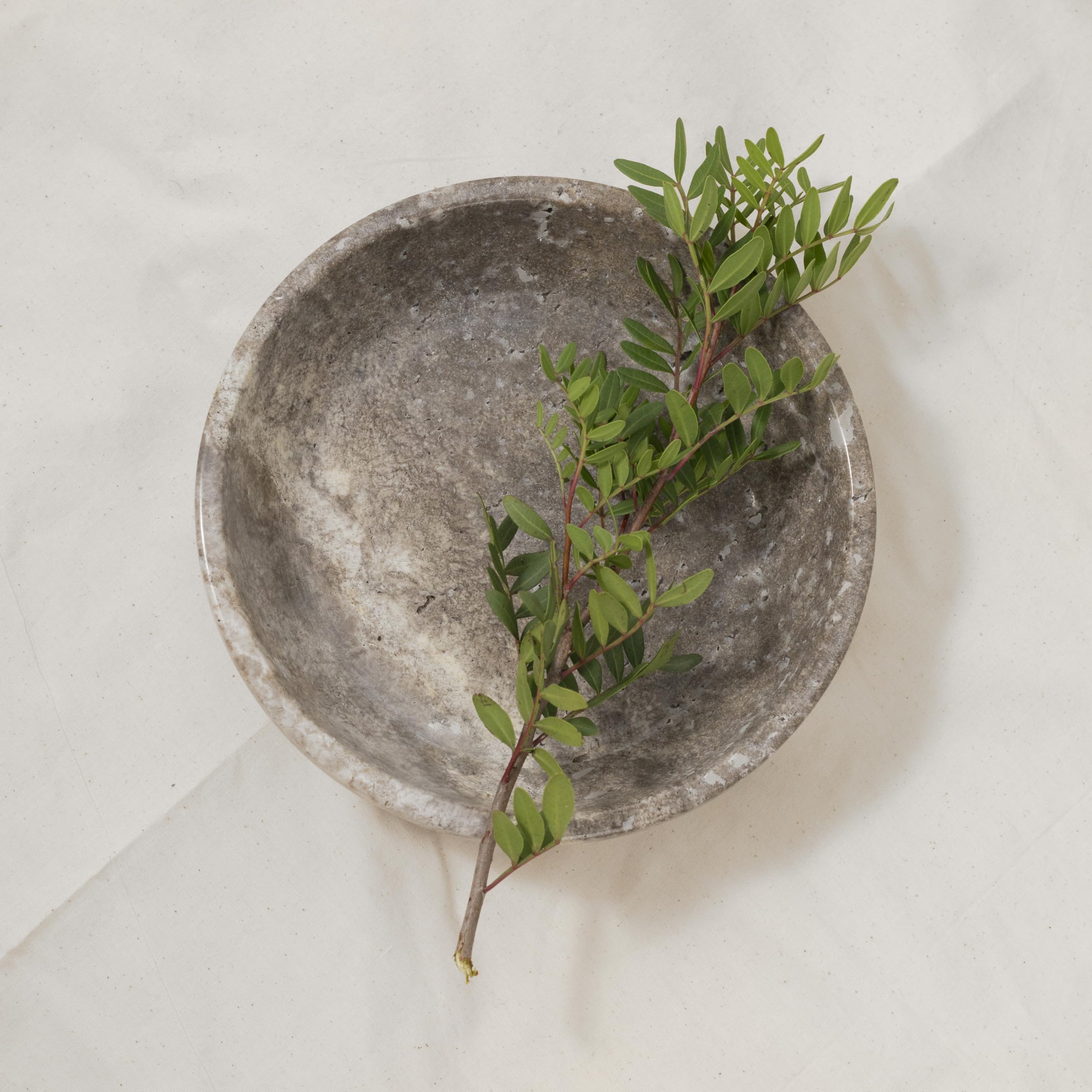 Shelf & Nook travertine natural bowl enhances living room decor with warm organic texture.