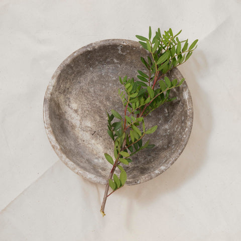 Shelf & Nook travertine natural bowl enhances living room decor with warm organic texture.