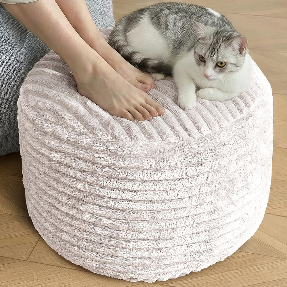 SHOUREN stuffed round pouf ottoman in beige provides soft seating and compact storage.