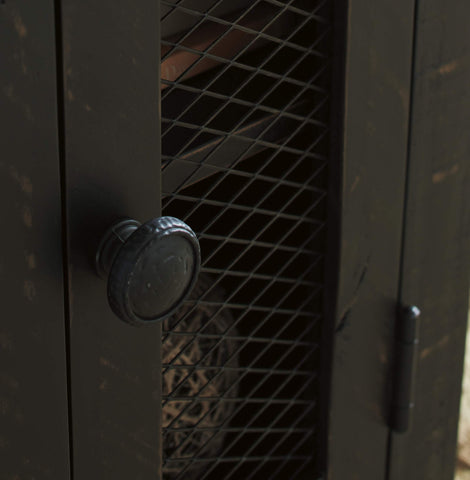 Wire mesh door with vintage hardware accents on Valebeck end table.