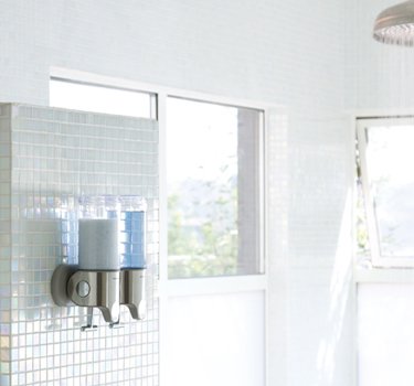 simplehuman wall-mount dispenser with separate shampoo and soap streams for easy access.