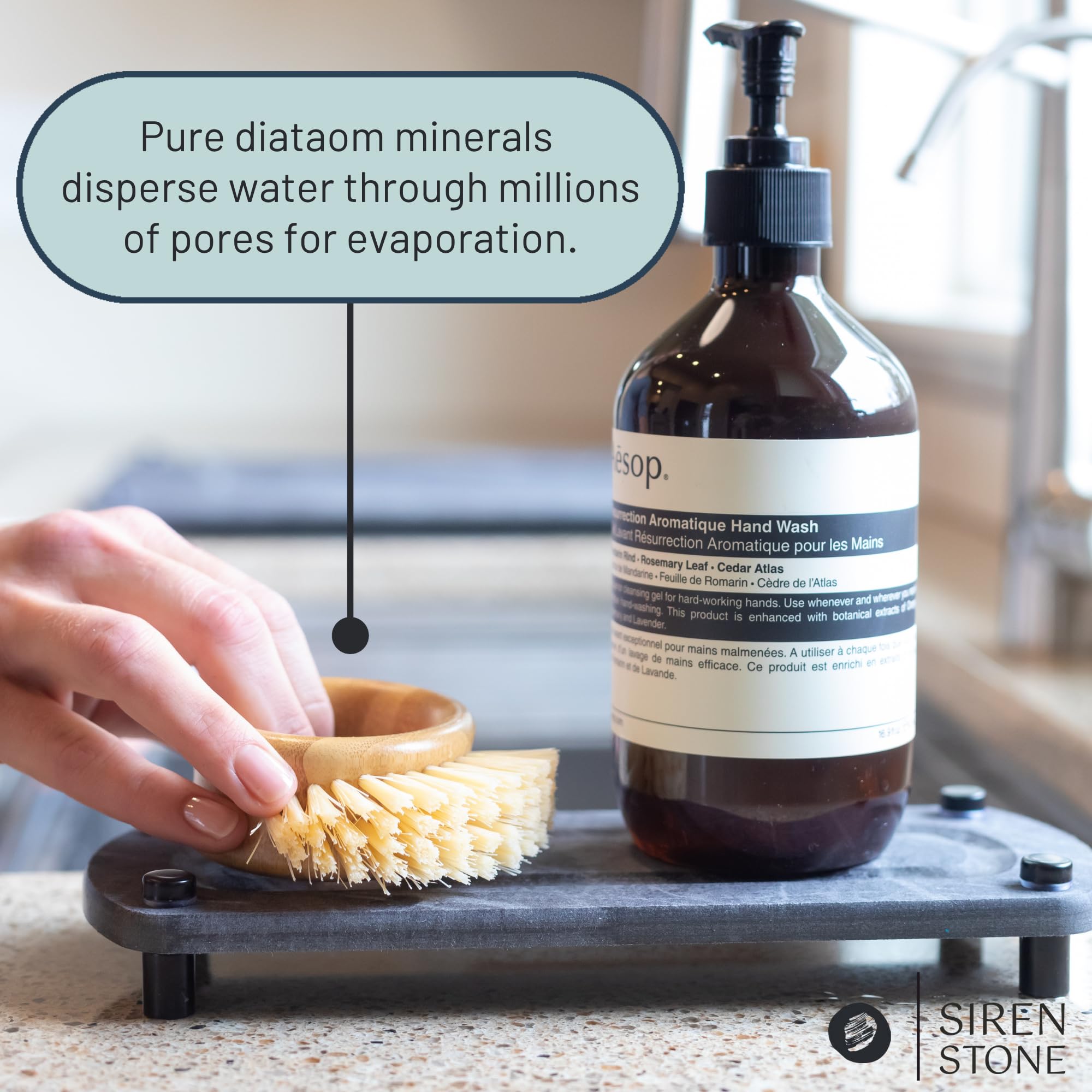 Siren Stone sink caddy on a dark slate surface concealing water spots.