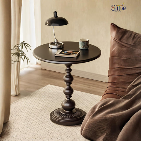 SJIE side table in living room setup beside a sofa.