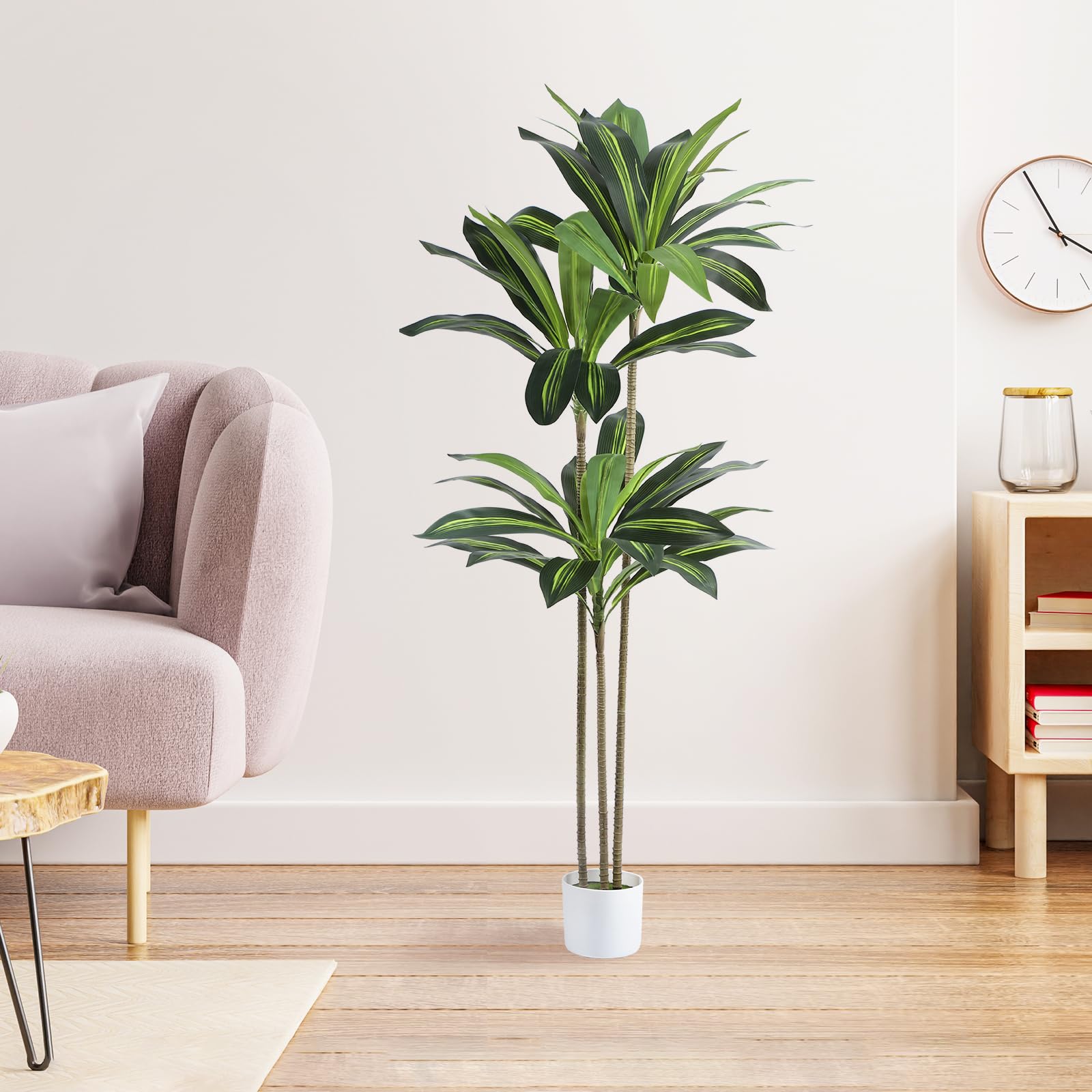 Skcoipsra white planter with artificial moss complements the tree.