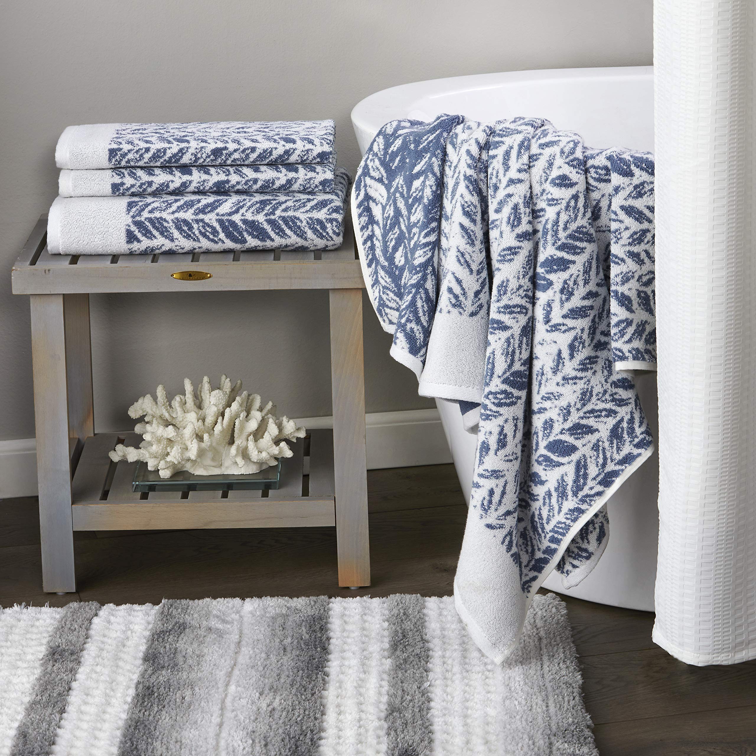 SKL Home Distressed Leaves hand towel displayed among towels for a cohesive bathroom setup