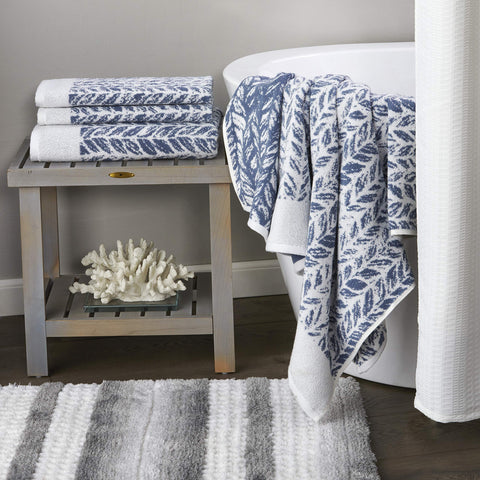 SKL Home Distressed Leaves hand towel displayed among towels for a cohesive bathroom setup