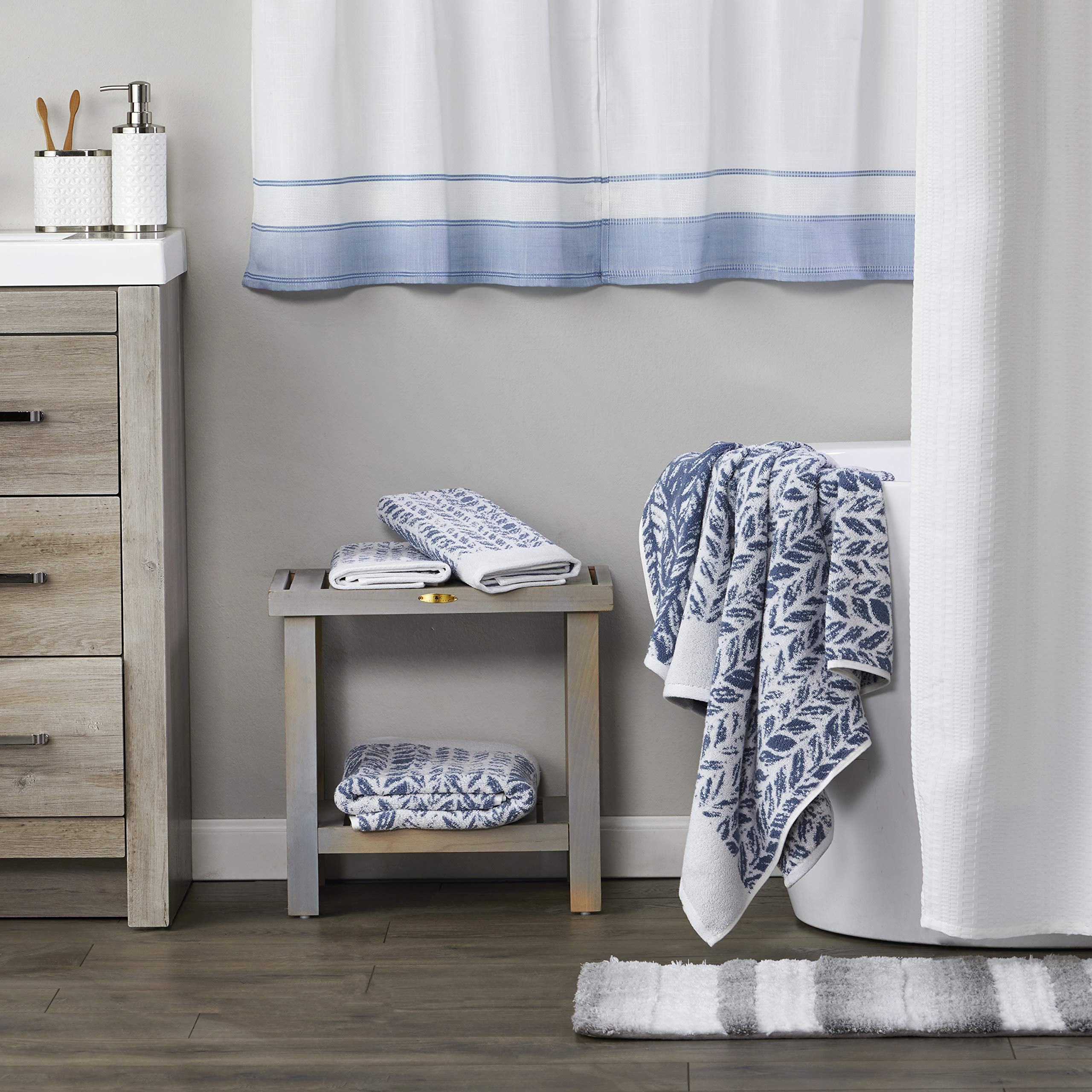 SKL Home Distressed Leaves hand towel drying a glass demonstrates quick absorption