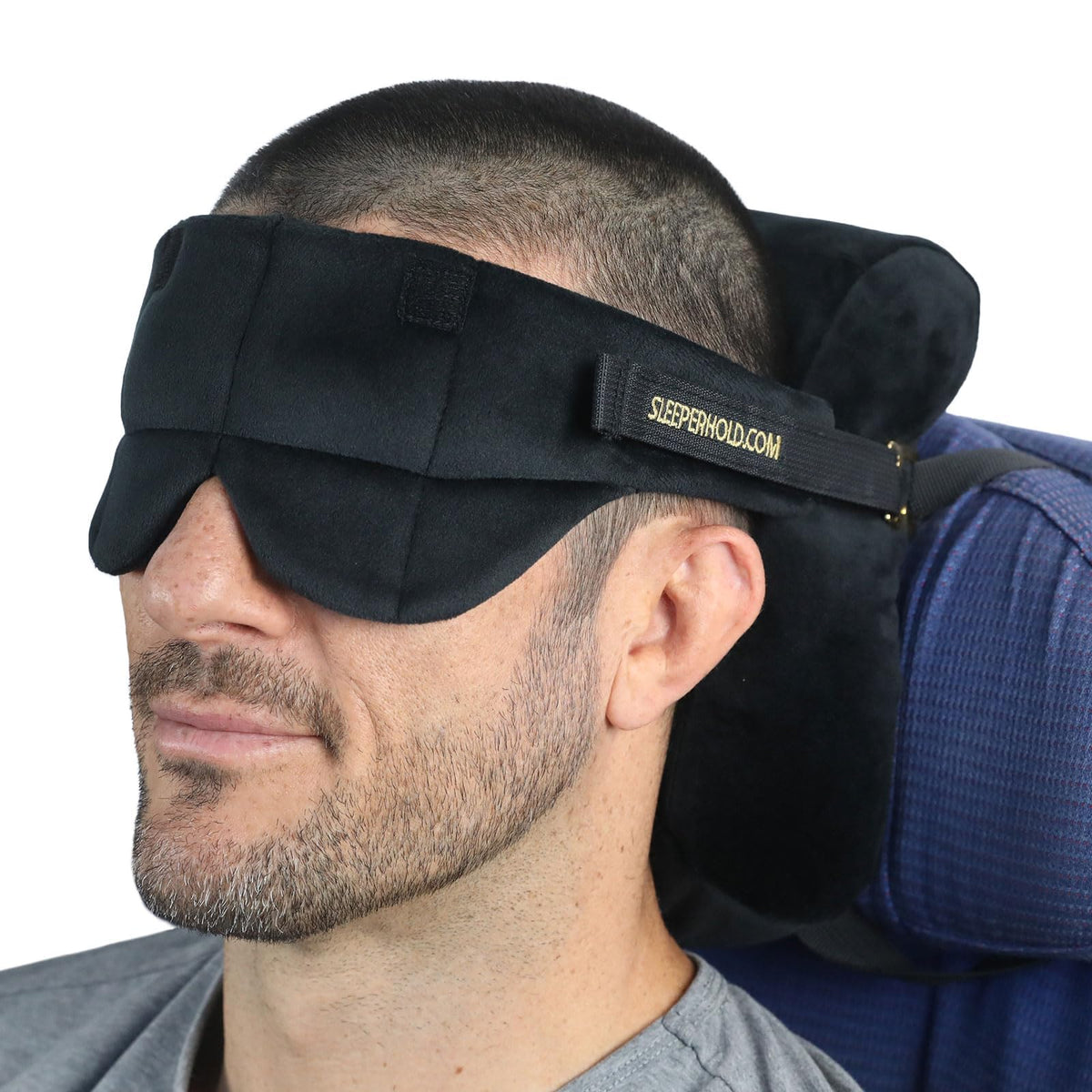 Sleeper Hold travel pillow attached to a seat-back for stable head support during flights