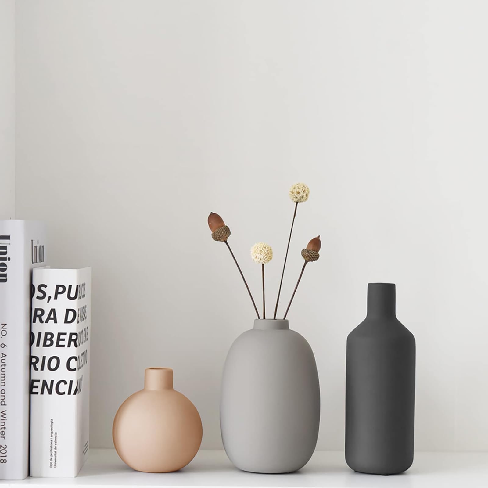 Smiletag vase trio on a bookshelf creates subtle botanical detail