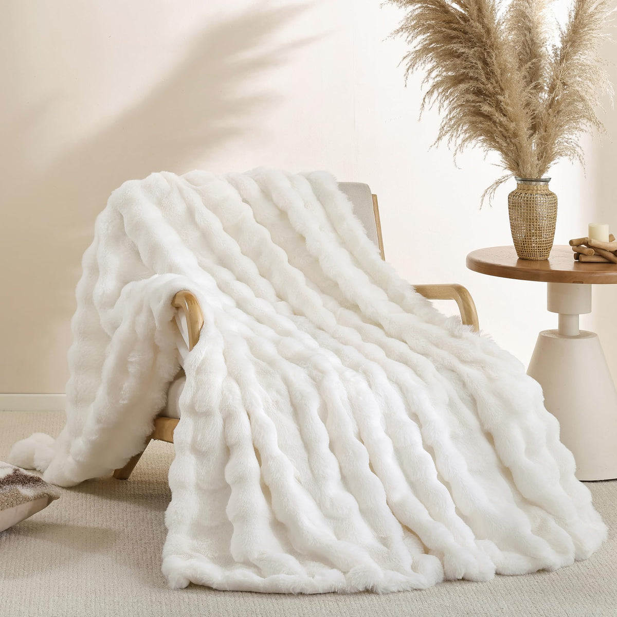 Smoofy cream white faux fur throw on couch, delivering luxurious warmth and a plush look.