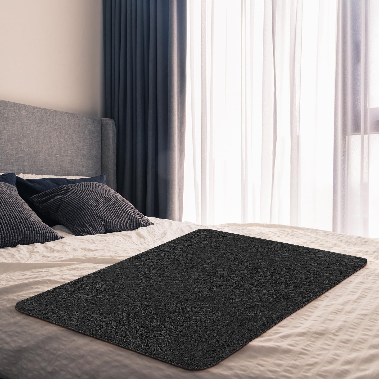 SmoothNovelty couples waterproof blanket, black bed protector, prevents spills on shared beds.