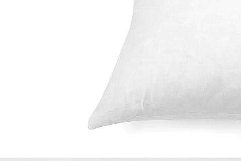 SNUG&COZY pack of 2 pillow inserts unpacked on bed