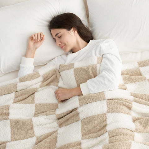 Snuggle Sac beige checker blanket on sofa enhances living room warmth.