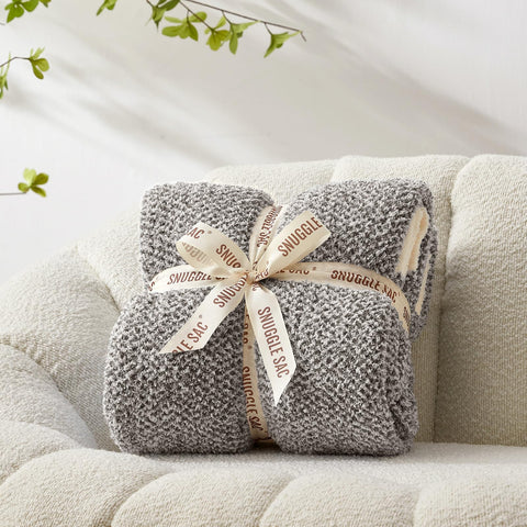 Snuggle Sac cozy throw on sofa for movie nights with family.