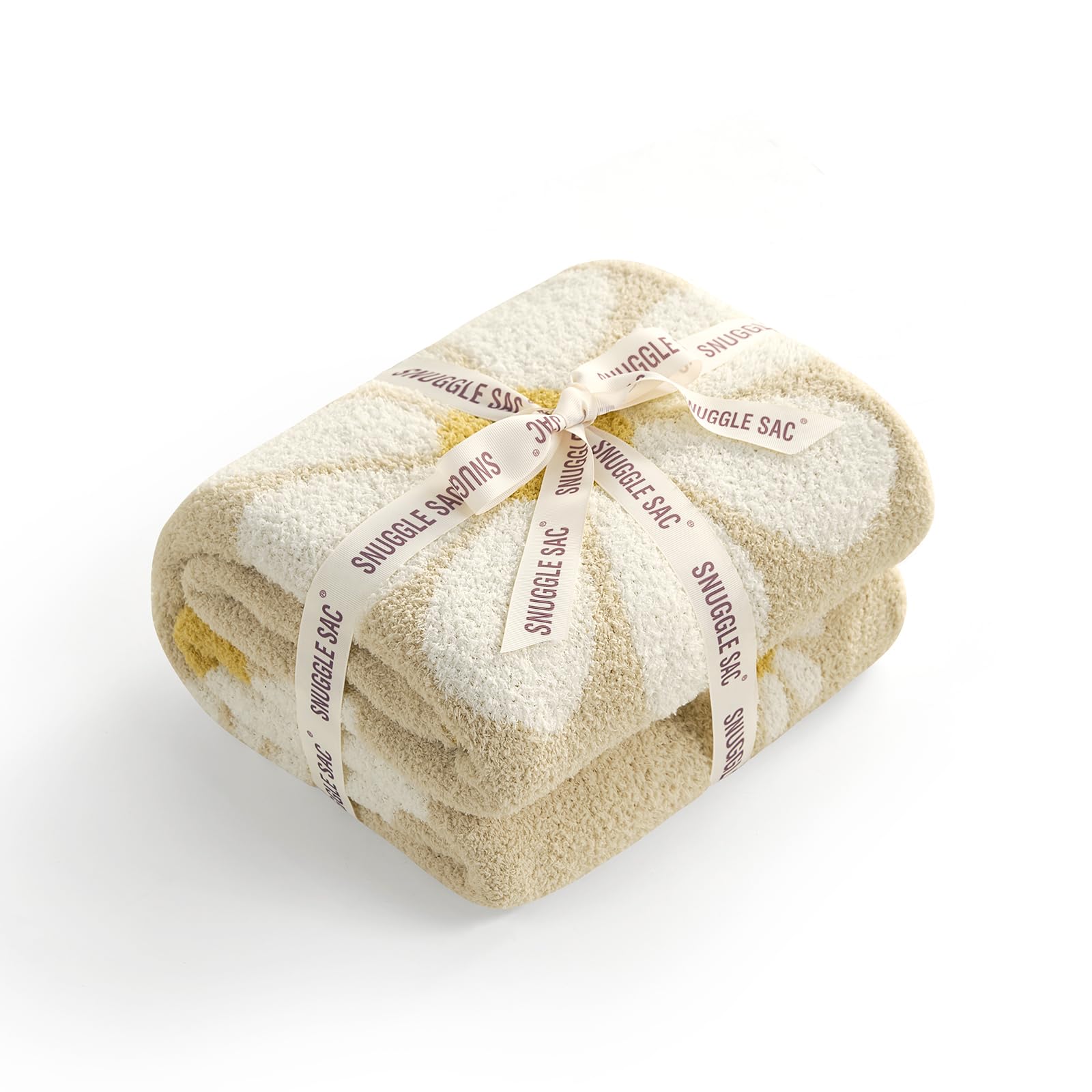 Snuggle Sac Flower blanket on bed and couch demonstrates versatile home use