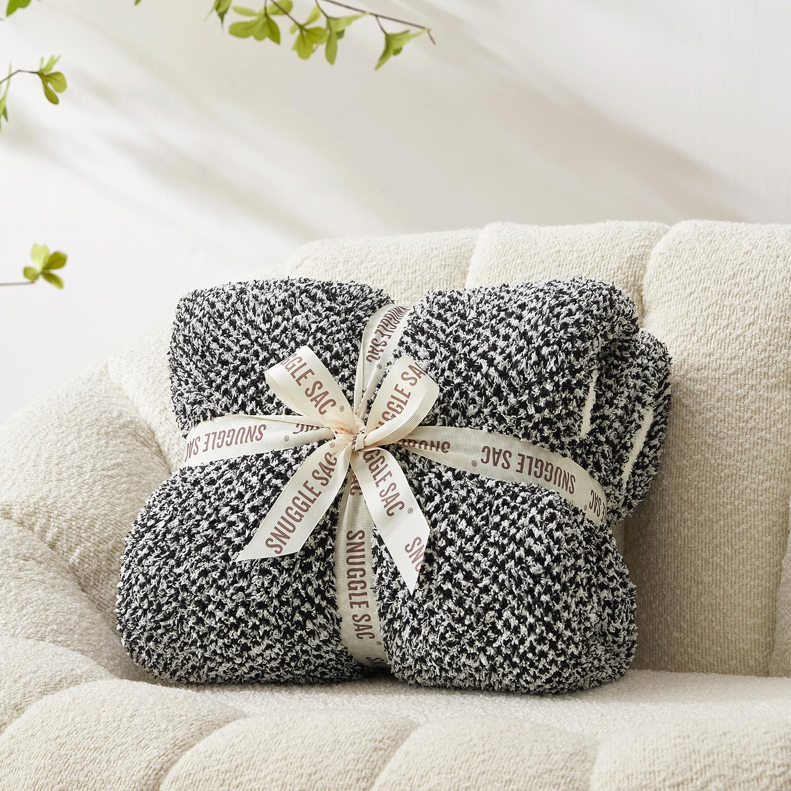 Snuggle Sac Heather Black on sofa demonstrates immediate cozy lounging.