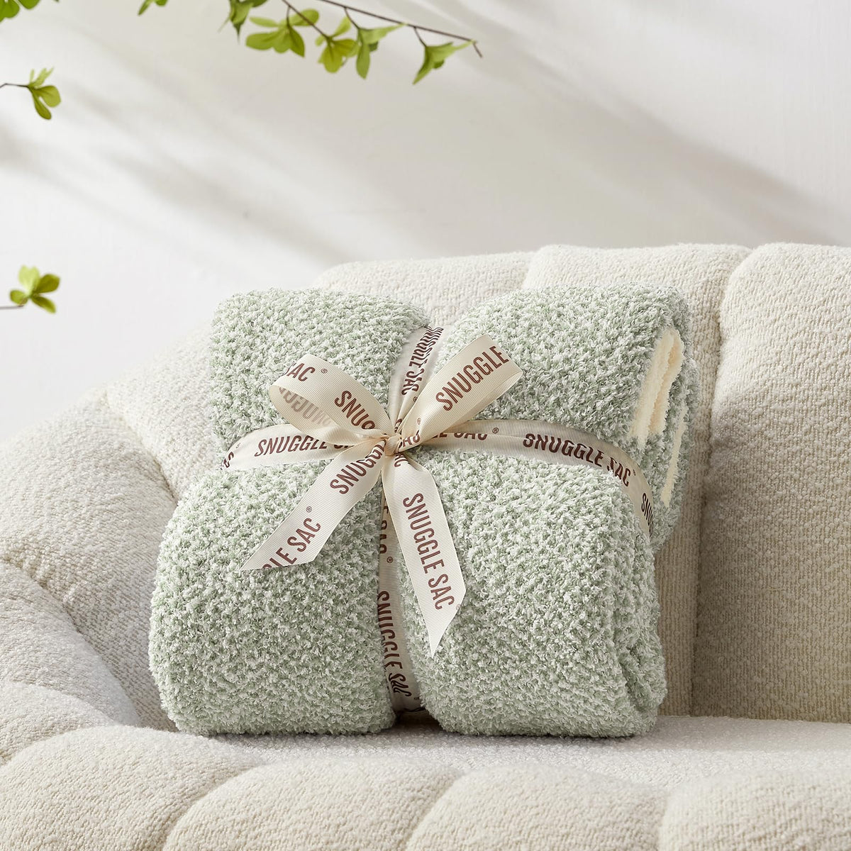 Snuggle Sac heather sage green throw, reversible knit for versatile styling and warmth.