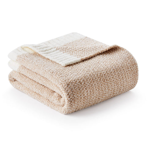 Snuggle Sac Heather Throw Blanket draped on a couch for cozy evenings