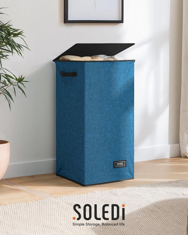SOLEDI blue laundry hamper shown in a bedroom for organization.