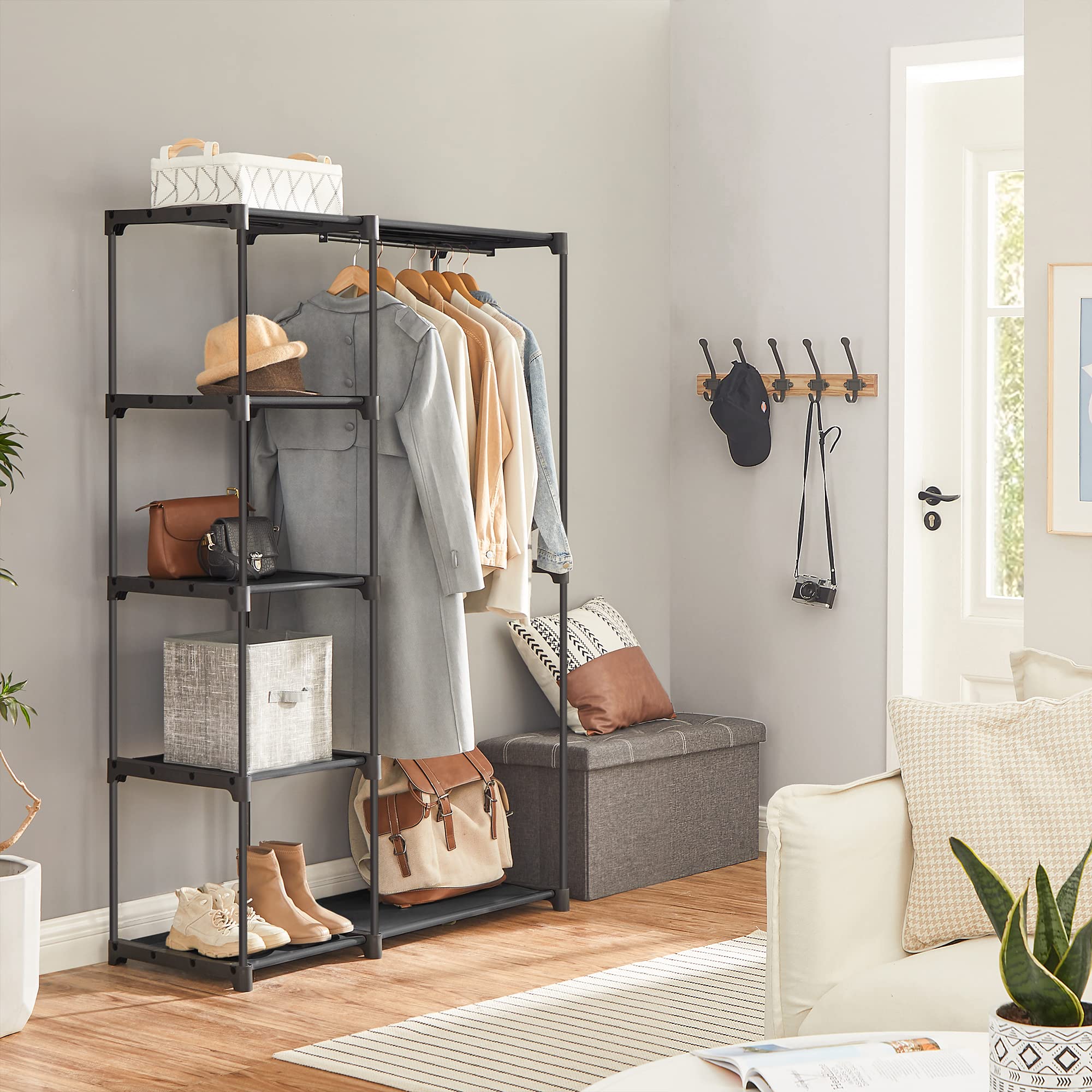 SONGMICS hanging rod with garments offers sturdy, accessible storage for outfits.