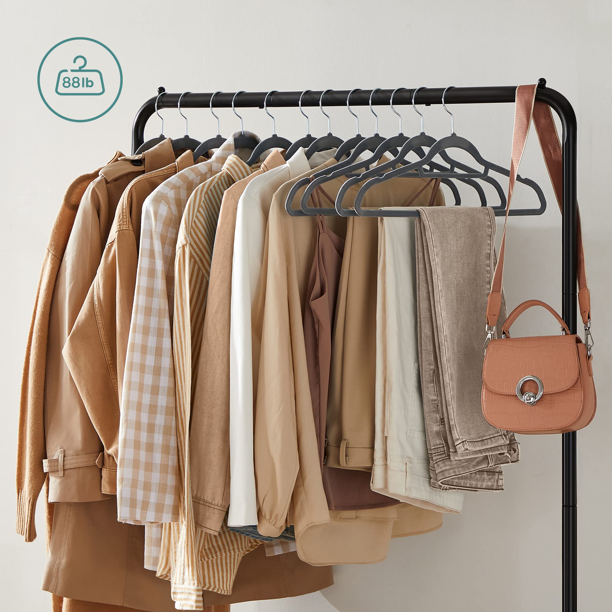 SONGMICS tall garment rack in a bedroom showcasing organized closet extension.