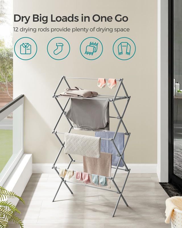 Songmics foldable rack in compact mode, easily stored behind wardrobe.