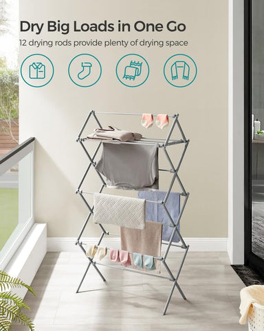 Songmics foldable rack in compact mode, easily stored behind wardrobe.