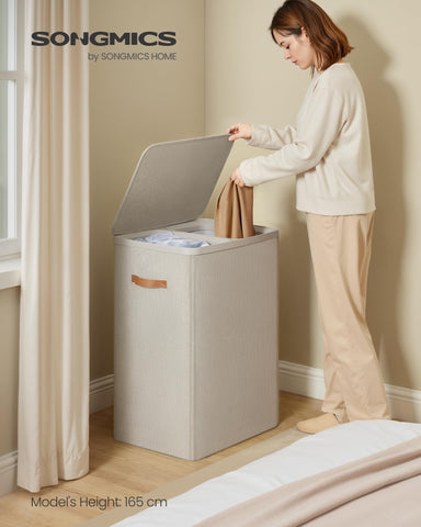 SONGMICS basket shows light and dark labels for guided laundry separation.