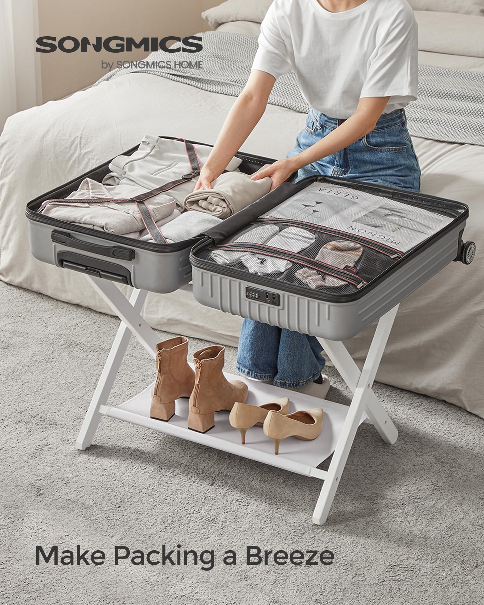 SONGMICS luggage rack top-load support demonstrating strong capacity for suitcases