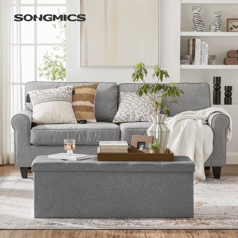 SONGMICS MAZIE storage chest with removable divider keeps blankets organized.