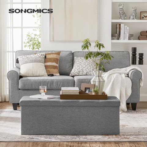 SONGMICS MAZIE storage chest with removable divider keeps blankets organized.
