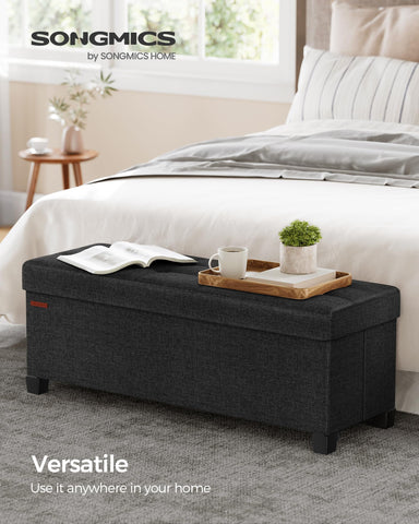 Songmics ottoman bench lid features metal corner guards for durability.