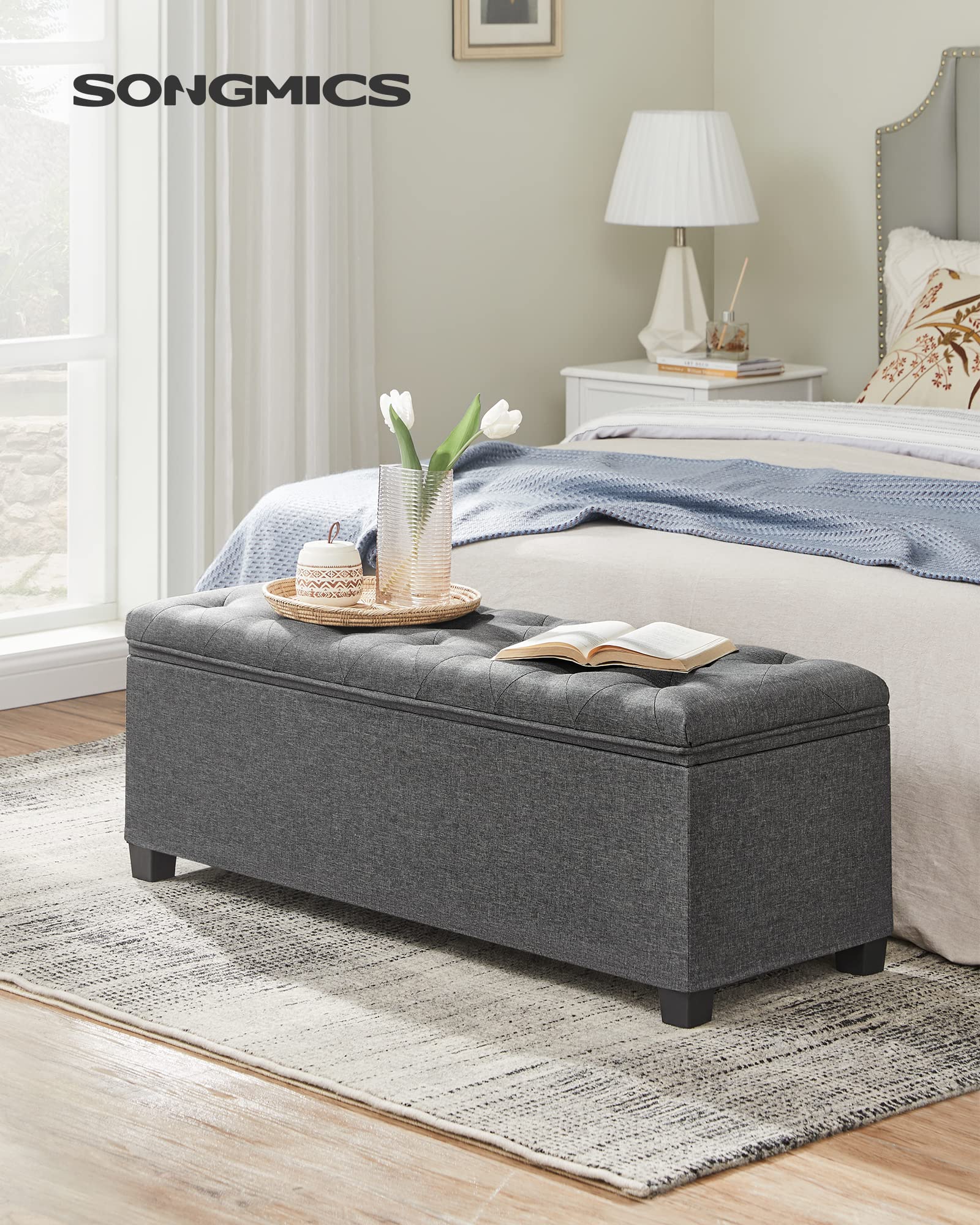 Songmics ottoman bench lid with metal corner guards for durable safety.