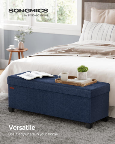 SONGMICS storage ottoman reveals a spacious interior for blankets and books.