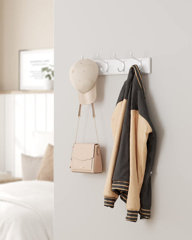 SONGMICS white coat rack in entryway blending with decor and providing storage.