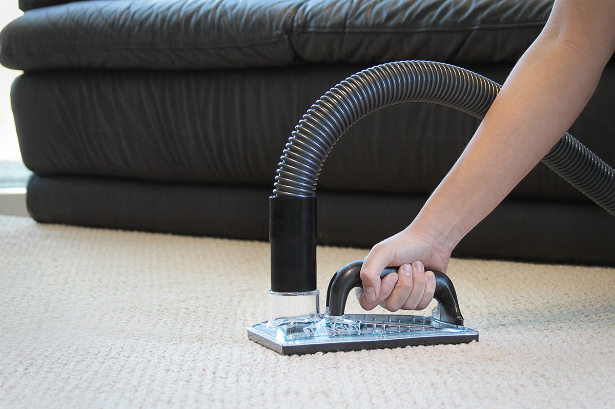 StainOut System 71-001 sub-surface extraction tool in use flushing contaminants from carpet padding.