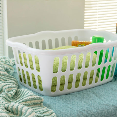 Sterilite white laundry basket with vented oval holes for air circulation.