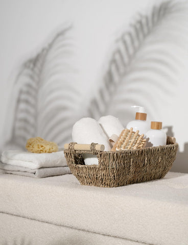StorageWorks seagrass basket holding toilet paper on a shelf.